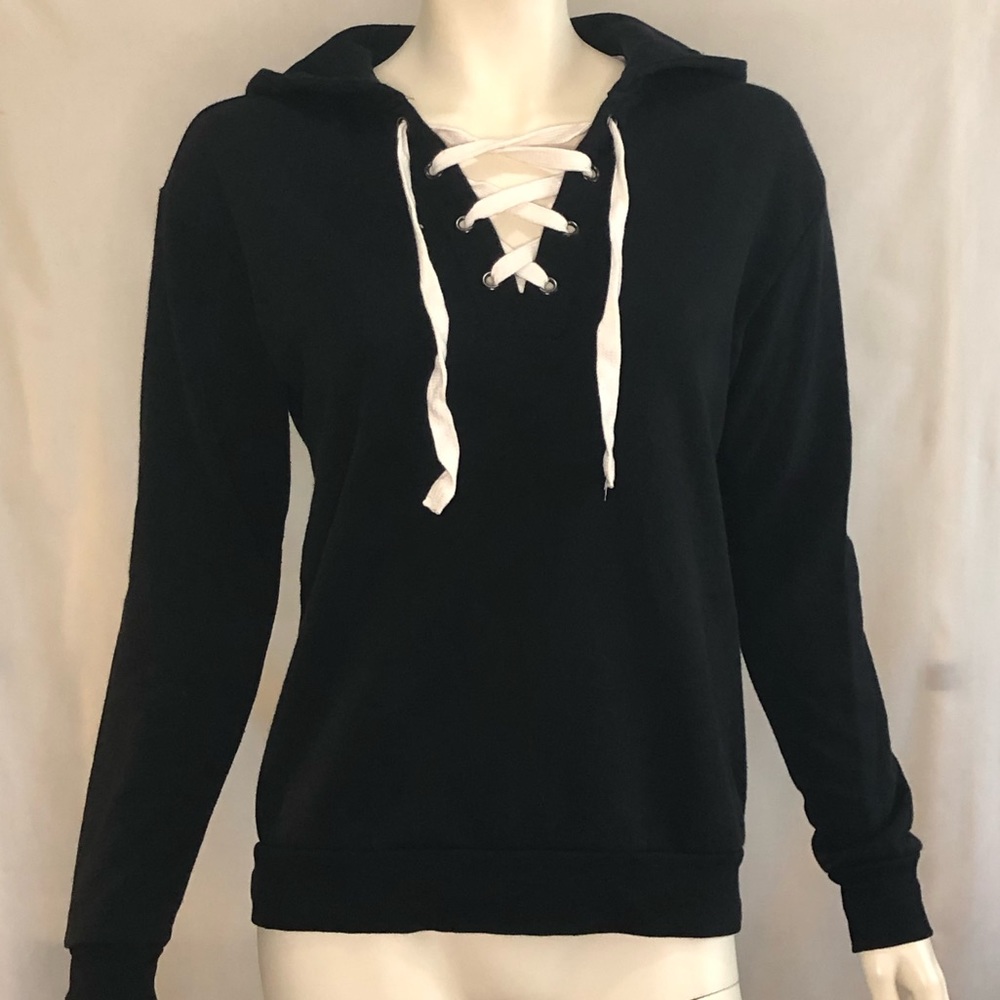 Woman’s black pull over hoodie with white laced front